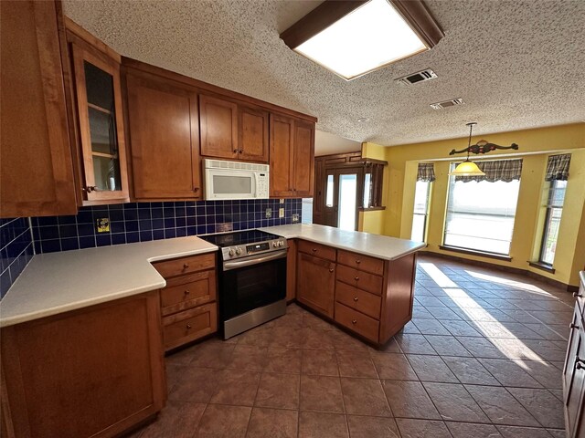 kitchen featuring electric stove, hanging light fixtures, backsplash, a textured ceiling, and kitchen peninsula