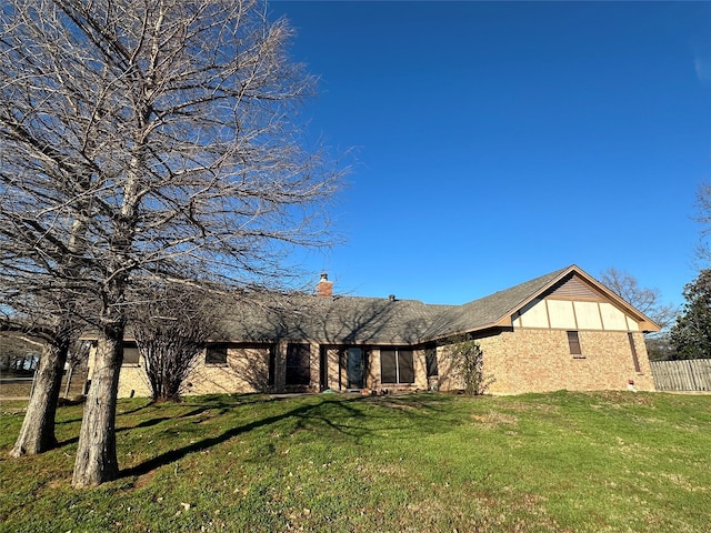 rear view of property with a yard