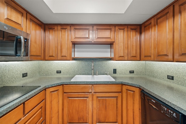 kitchen featuring tasteful backsplash, sink, and black appliances