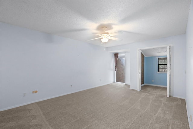 carpeted empty room featuring a textured ceiling and ceiling fan