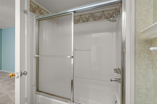 bathroom with bath / shower combo with glass door