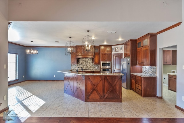 kitchen with pendant lighting, an island with sink, a kitchen bar, ornamental molding, and stainless steel appliances