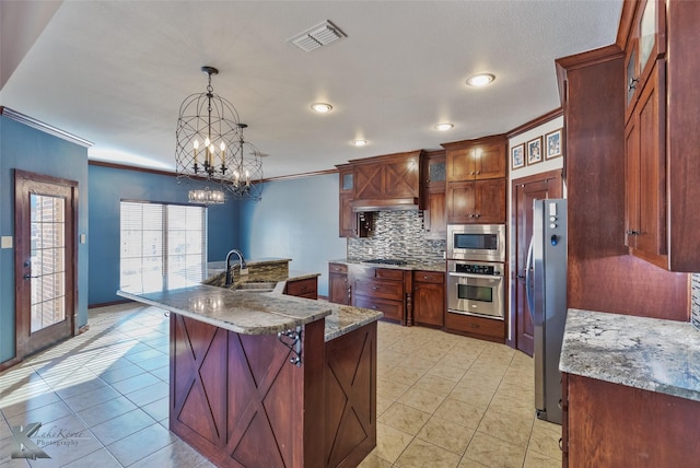 kitchen featuring tasteful backsplash, sink, a breakfast bar area, hanging light fixtures, and stainless steel appliances