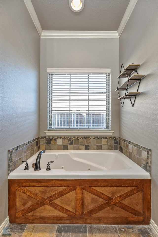 bathroom with ornamental molding and a bath