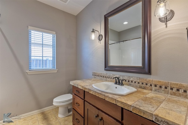 bathroom featuring tile patterned flooring, vanity, and toilet