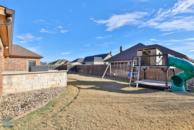 view of yard featuring a hot tub and a playground