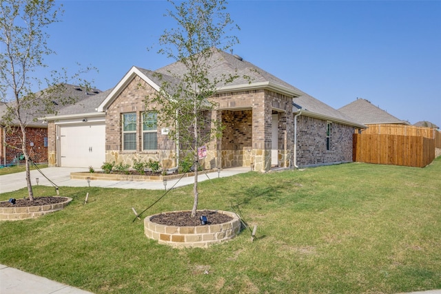 view of front of property featuring a front yard and a garage