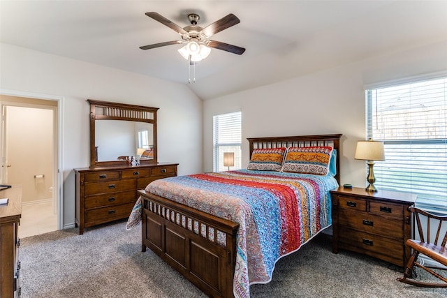 bedroom with lofted ceiling, ensuite bathroom, ceiling fan, and carpet flooring