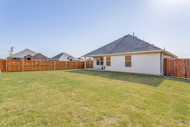 back of property featuring a yard and a patio area