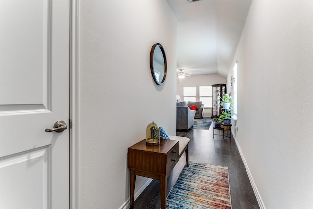 corridor featuring dark hardwood / wood-style flooring and lofted ceiling