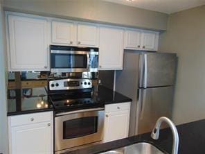 kitchen with white cabinets, stainless steel appliances, and sink