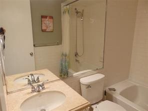 full bathroom with toilet, shower / bathtub combination with curtain, and sink