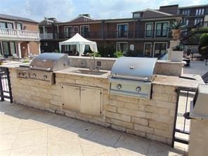 view of patio / terrace with area for grilling, sink, and an outdoor kitchen