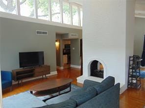 living room featuring hardwood / wood-style flooring and a high ceiling