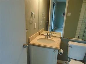 bathroom with vanity, an enclosed shower, and toilet