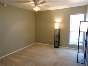 carpeted empty room with ceiling fan