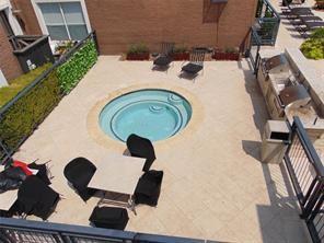 view of swimming pool featuring an in ground hot tub