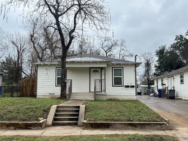 bungalow-style home with a front lawn