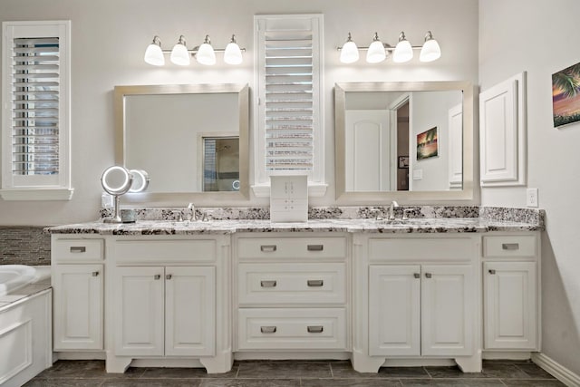 bathroom with vanity and a bath