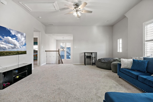 living room featuring a wealth of natural light, light carpet, and ceiling fan