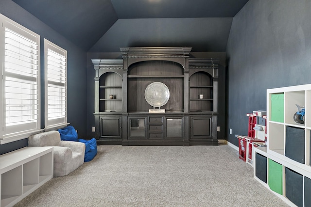 rec room featuring carpet and lofted ceiling