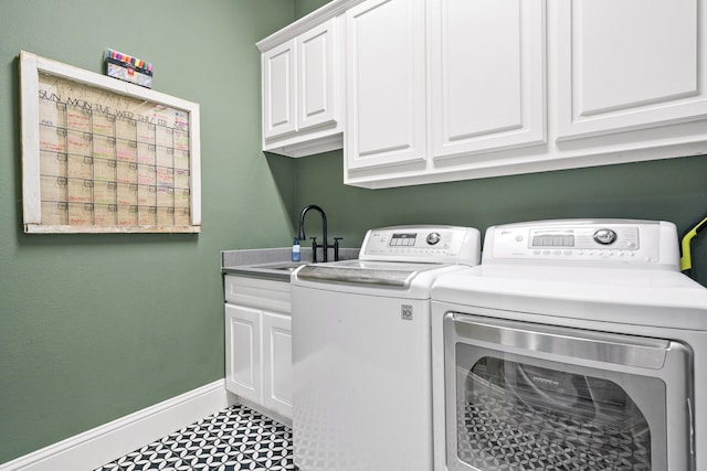 washroom featuring sink, cabinets, and independent washer and dryer