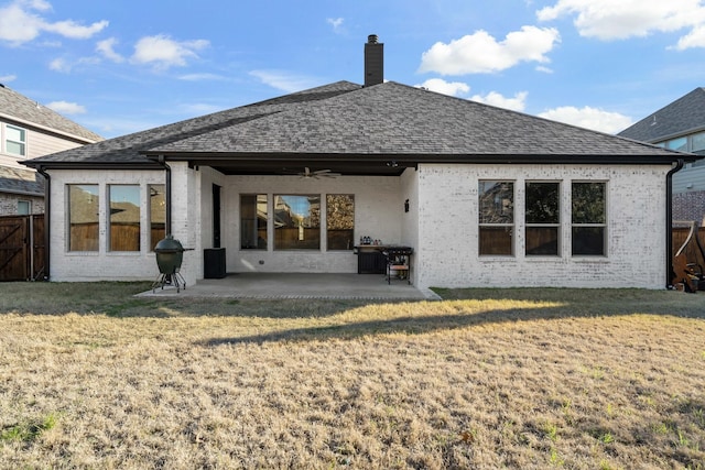 rear view of house with a lawn, ceiling fan, and a patio