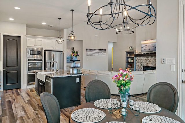 dining space featuring hardwood / wood-style floors and sink