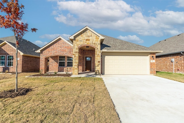 view of front of home with a front yard and a garage