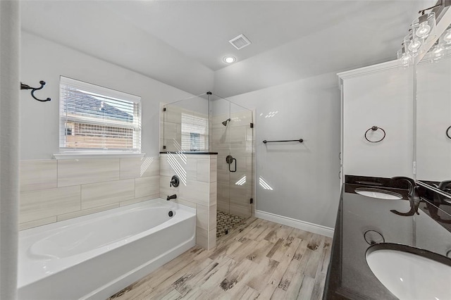 bathroom featuring vanity, shower with separate bathtub, and hardwood / wood-style flooring