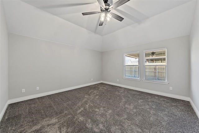 empty room with dark colored carpet, ceiling fan, and lofted ceiling