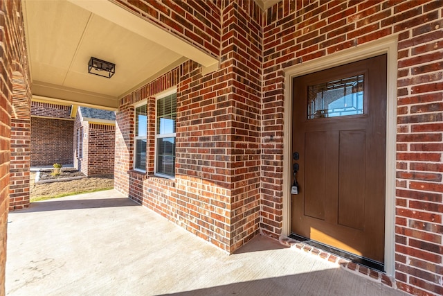 view of exterior entry with covered porch