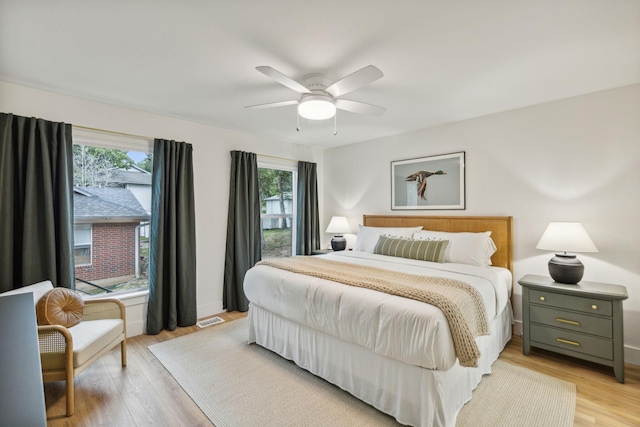 bedroom with ceiling fan and light wood-type flooring