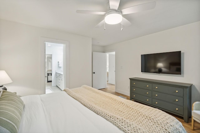 bedroom featuring ceiling fan, connected bathroom, and light wood-type flooring