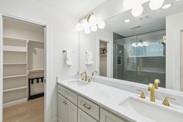 bathroom featuring vanity, hardwood / wood-style floors, and walk in shower