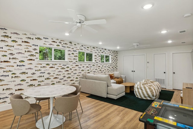 living room with wood-type flooring and ceiling fan