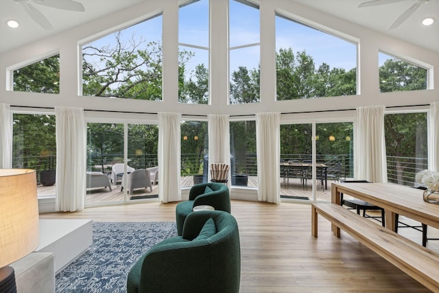 sunroom featuring ceiling fan, a wealth of natural light, and vaulted ceiling