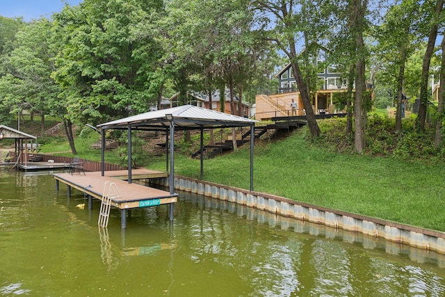 dock area featuring a water view and a yard