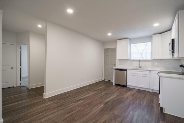 kitchen featuring dark wood-type flooring, white cabinets, appliances with stainless steel finishes, and sink