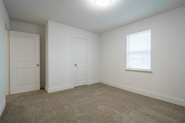 unfurnished bedroom featuring carpet floors and a closet