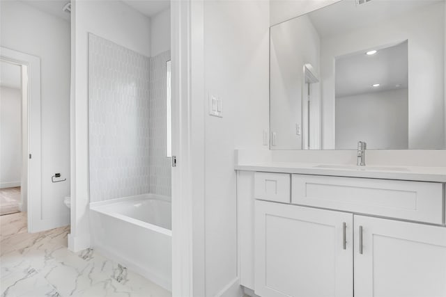 full bathroom featuring vanity, tiled shower / bath combo, and toilet