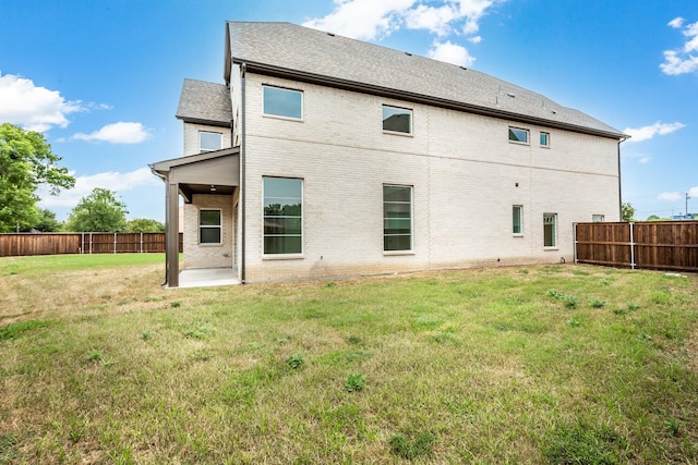 back of house featuring a lawn