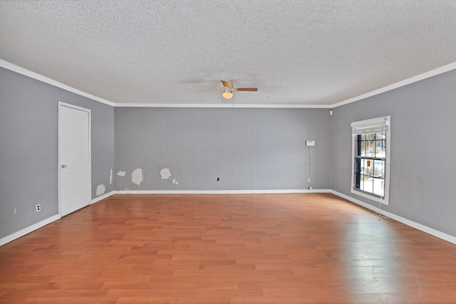 empty room featuring a textured ceiling, light wood-type flooring, ceiling fan, and crown molding