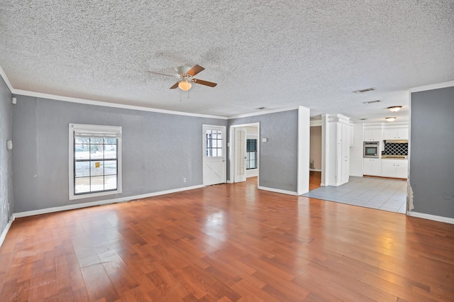 unfurnished living room featuring a textured ceiling, ceiling fan, crown molding, and light hardwood / wood-style flooring