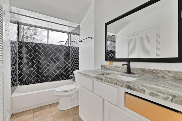 full bathroom featuring tile patterned floors, toilet, vanity, and tiled shower / bath