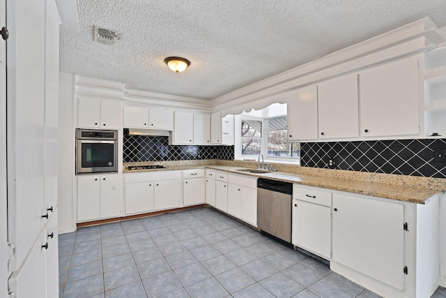 kitchen featuring sink, white cabinets, stainless steel appliances, and light tile patterned floors