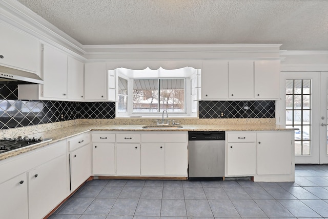 kitchen with a textured ceiling, stainless steel appliances, sink, light tile patterned floors, and white cabinets