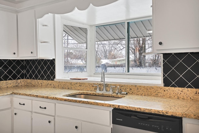 kitchen with decorative backsplash, dishwasher, white cabinets, and sink