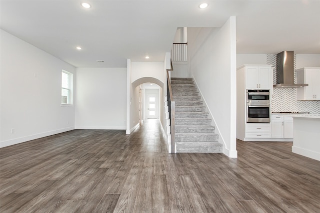 unfurnished living room with dark hardwood / wood-style flooring