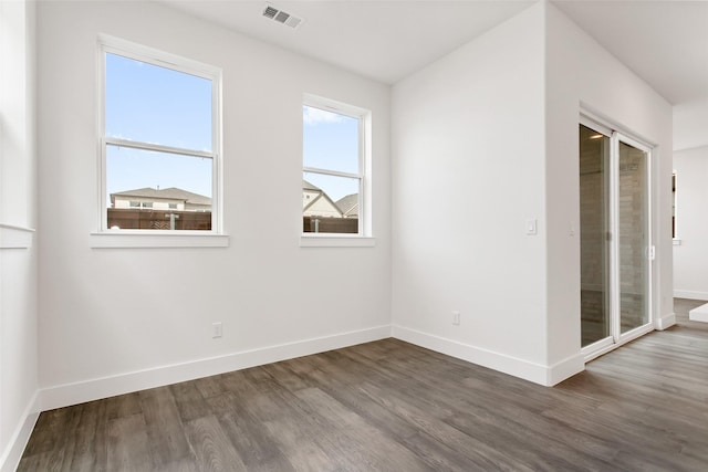 spare room featuring dark wood-type flooring